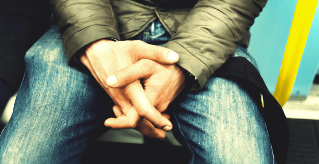 Person holding their hand symbolizing the mental and emotional weight of OCD.