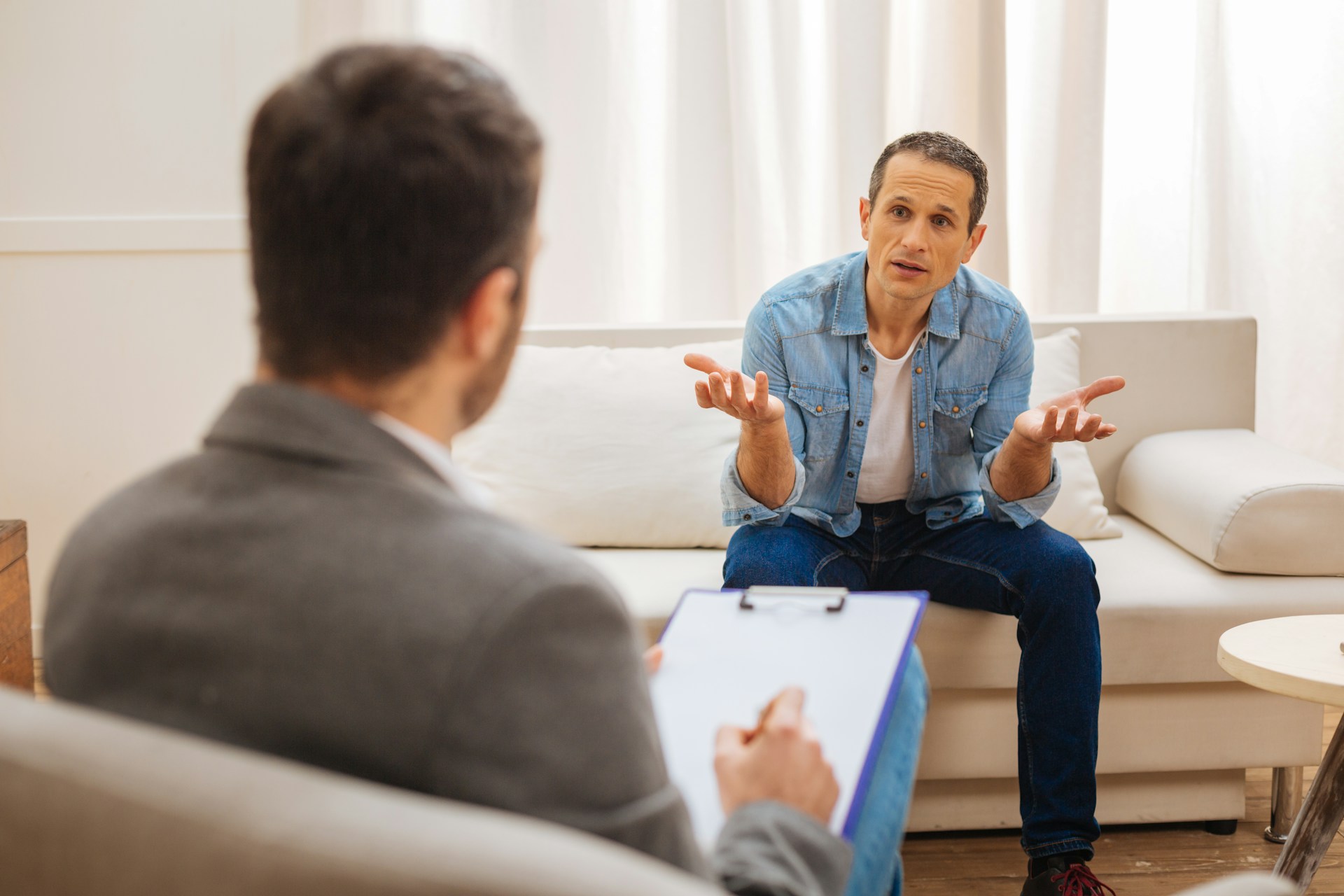 A therapist and patient in conversation during a counseling session, representing questions to ask when finding an integrative psychotherapist.