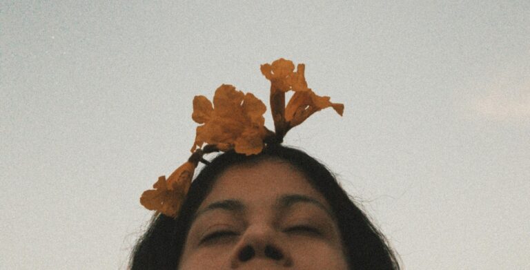 Self-worth and self-acceptance concept image with woman and flowers, representing therapy, emotional healing, and mental wellness